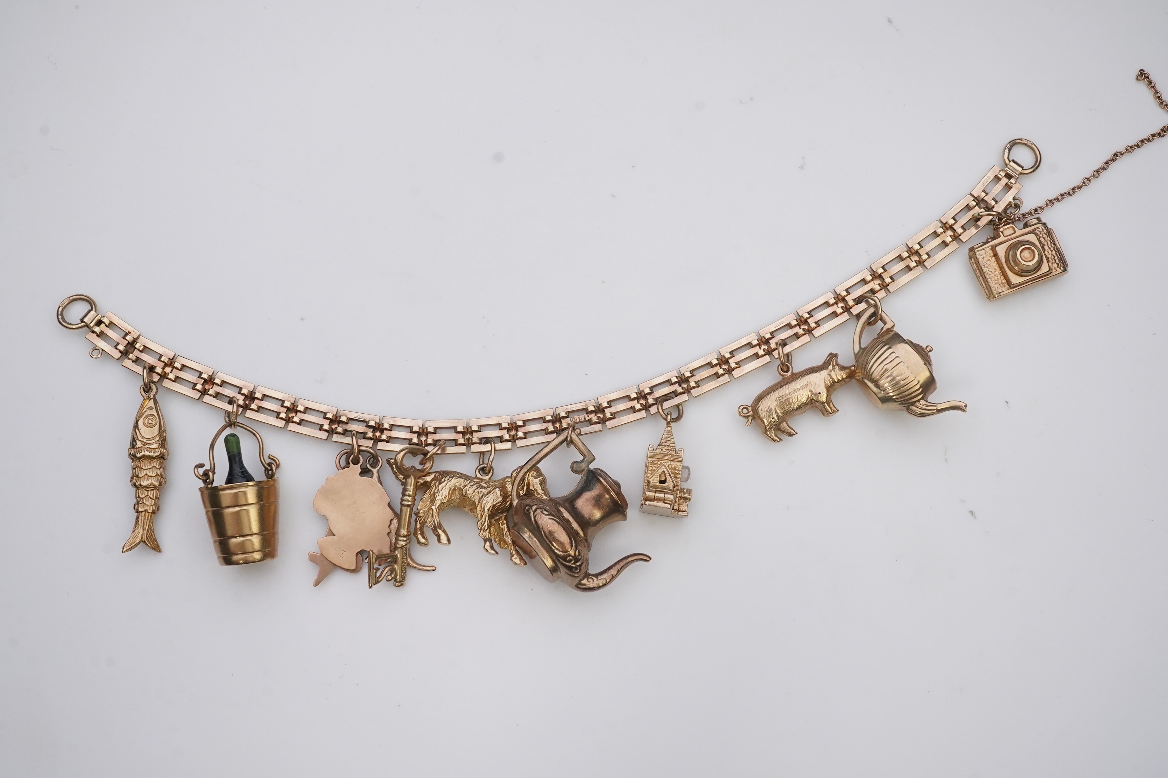 A charm bracelet, mid 20th century